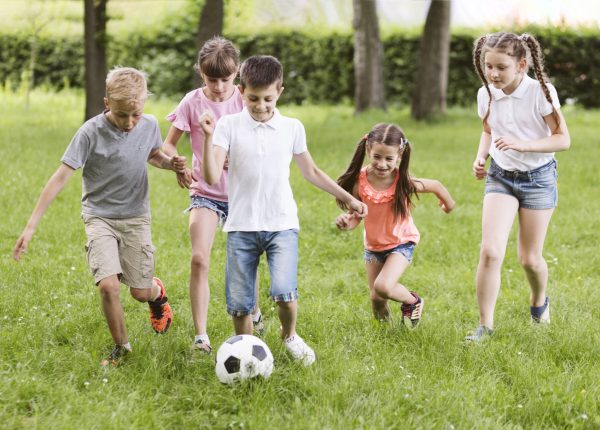 children-playing-football-outside