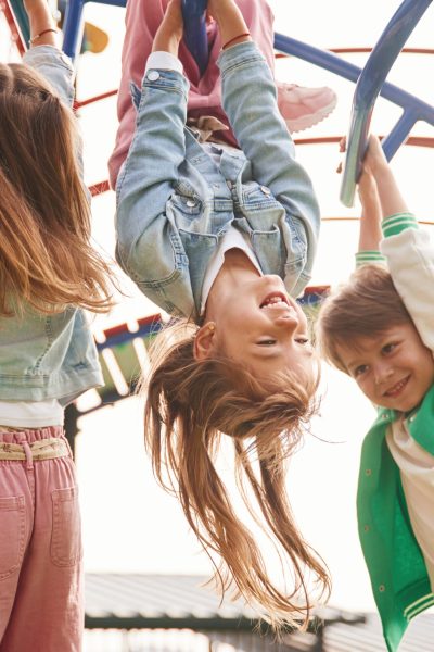 Hanging upside down. Kids are having fun on the playground