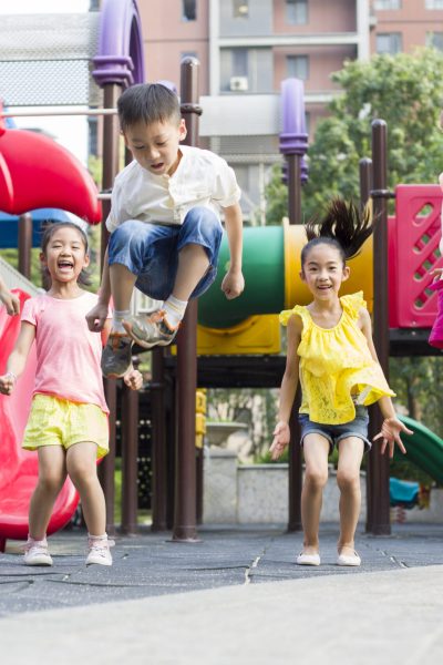 Happy Chinese children playing in park