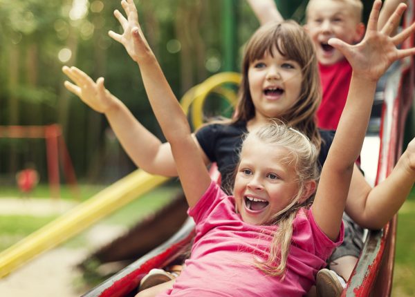 Happy kids playing on slide